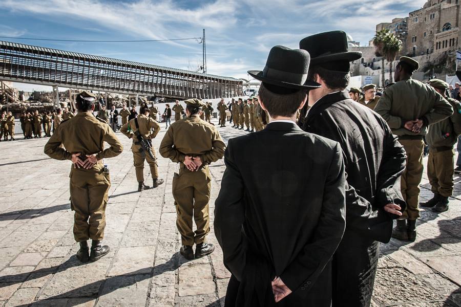 Orthodox Jews watch IDF soldiers during their oath ceremony on Western Wall Plaza, Jerusalem, in March 2013